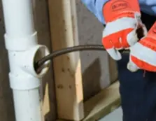 cleaning the sewer pipes through a clean out