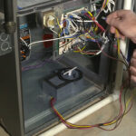 man installing ionizer in ac system
