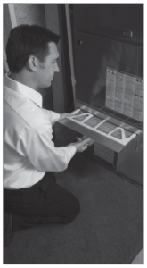 Man changing pop up filter in AC